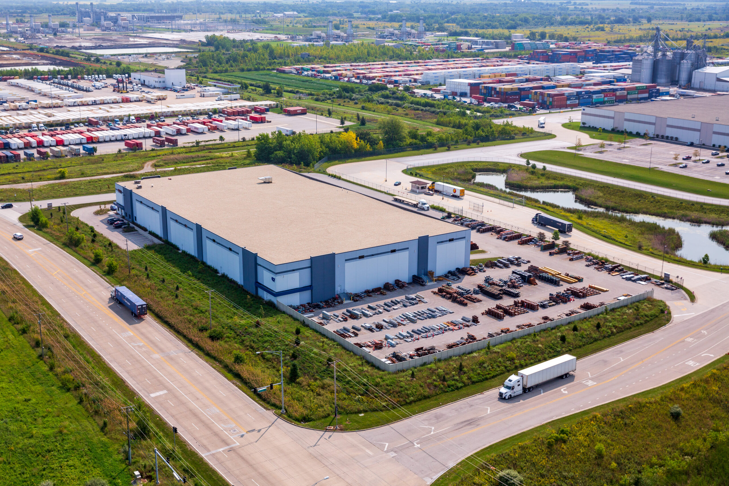 Aerial Photo Of Warehouse With Streets Surrounding the Facility With Trucks